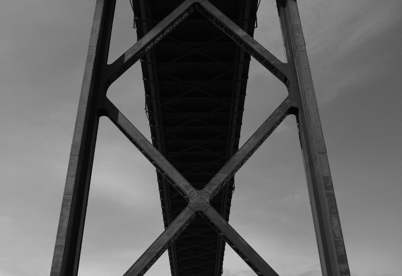 Underside of a riveted steel truss bridge